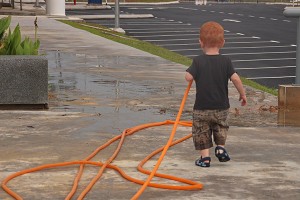 Jace at EV World Hotel in Kuala Lumpur. Who needs toys when there's a garden hose lying around...